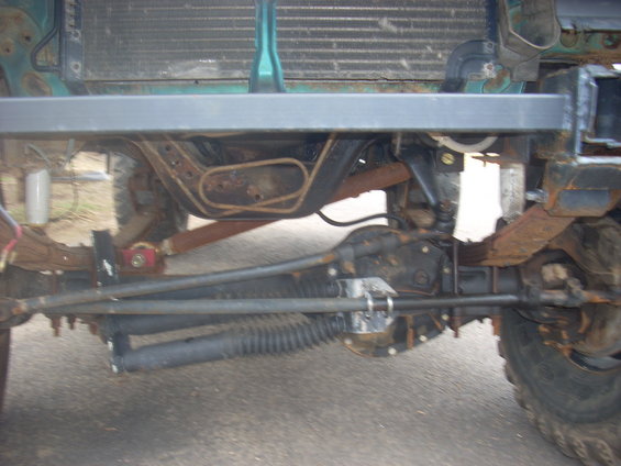 Vehicle undercarriage with rusty suspension components and steering linkage