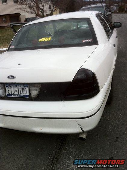 White Ford Crown Victoria with tinted taillights and a "JEGS" sticker on the rear window