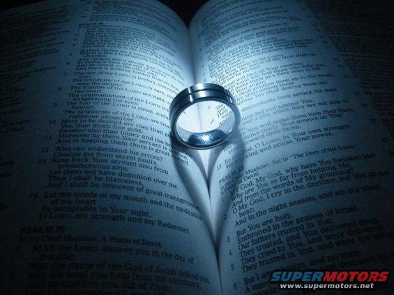 Ring on open bible, casting a heart shadow