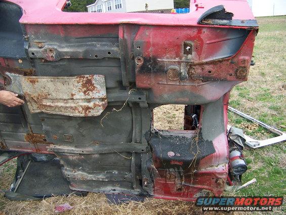 Red Jeep YJ frame, underside view. Visible rust and damage