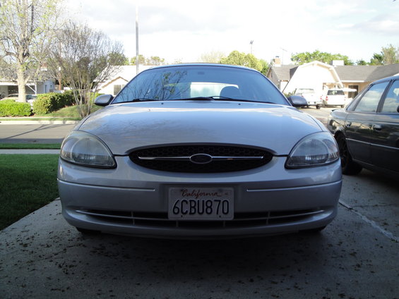 Front view of a silver Ford Taurus with a California license plate reading 6CBU870