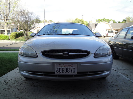 Silver 2003 Ford Taurus front view, license plate 6CBU870, parked on driveway