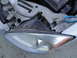 2003 Ford Taurus - Close-up of a car's headlight assembly, with tools nearby, suggesting maintenance or repair work.