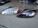 2003 Ford Taurus - A comparison of a clear headlight and a blacked-out headlight, likely for a car part replacement or modification.