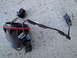 2003 Ford Taurus - A detached headlight wiring harness lies on a concrete surface, showing its connectors and wiring.