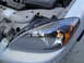 2003 Ford Taurus - The front headlight assembly is visible on a 2003 Ford Taurus.