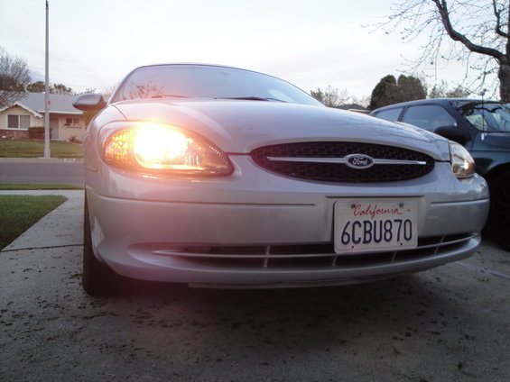 2003 Ford Taurus front grille and illuminated headlights. California license plate 6CBU870