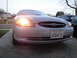2003 Ford Taurus - Front view of a 2003 Ford Taurus with its headlights on, showing the grille and license plate.