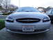 2003 Ford Taurus - A silver 2003 Ford Taurus is parked in a driveway, facing the camera.
