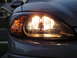2003 Ford Taurus - Close-up of the illuminated headlight assembly on a 2003 Ford Taurus.