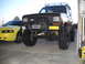 1986 Ford Bronco II - Modified 1986 Ford Bronco II and a yellow Ford Mustang are parked side-by-side.