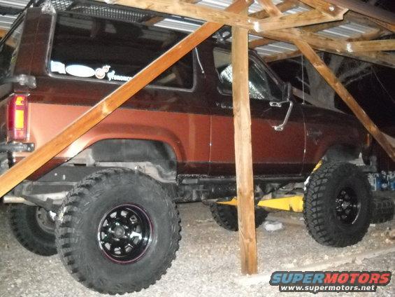 Brown 1986 Ford Bronco II parked under a wooden structure