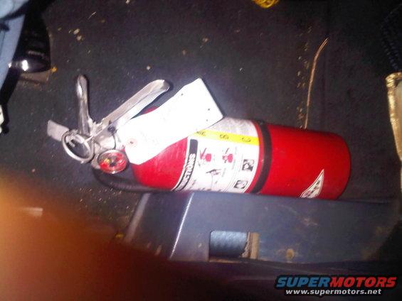 fire extinguisher lying on floor of vehicle