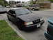 2003 Ford Taurus - This black sedan, possibly a first-generation Ford Taurus, is parked on a residential street.
