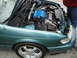 2003 Ford Taurus - A teal car's engine bay is open, revealing the engine and various components.