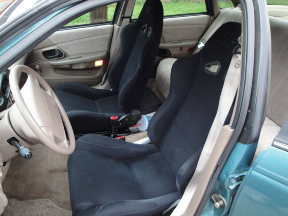 Car interior with black racing seats and beige dashboard