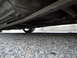 2003 Ford Taurus - Low angle shot of a car's undercarriage, revealing the exhaust and a wheel.