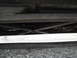 2003 Ford Taurus - The undercarriage of a vehicle is visible, showing metal supports and components.