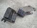 2003 Ford Taurus - Two worn engine mounts, one with a metal bracket attached, lie on a concrete surface.