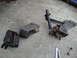 2003 Ford Taurus - Three engine mounts are laid out on a concrete surface. One mount includes a small shock absorber.