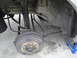 2003 Ford Taurus - Close-up of a vehicle's rear drum brake assembly and suspension.