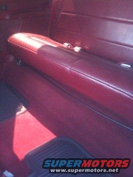red vinyl seats and carpet inside a vehicle