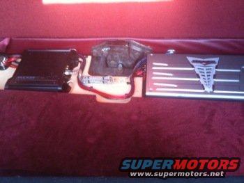 Car interior with three amplifiers mounted on a red surface