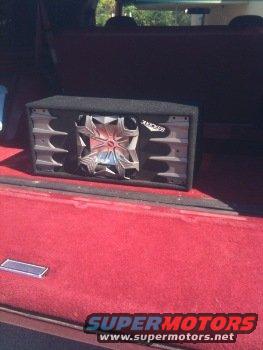 Subwoofer in red carpeted cargo area