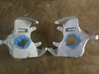 pair of silver metal parts with blue tape