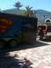1995 Ford Bronco - A red 1995 Ford Bronco is parked next to a trailer with a Superman logo.