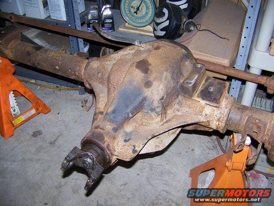 rusty rear axle assembly on jack stands