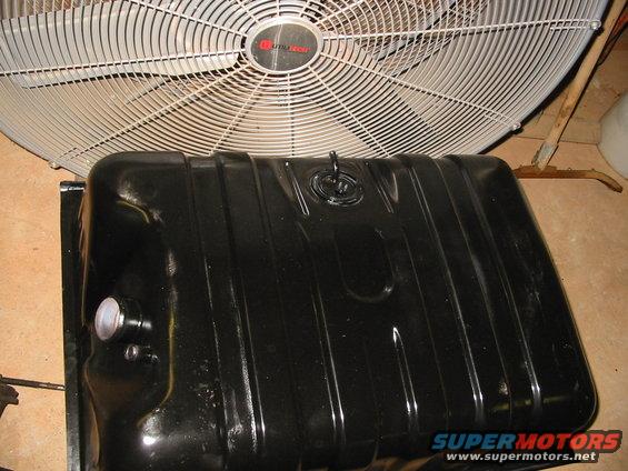 Black fuel tank with a large industrial fan behind it