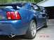 1999 Ford Mustang - Rear view of a blue 1999 Ford Mustang, showing its distinctive taillights and spoiler.