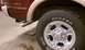 1999 Ford Expedition - Close-up of the rear wheel and chrome exhaust on a 1999 Ford Expedition.