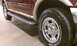 1999 Ford Expedition - Close-up of the side step and wheel of a 1999 Ford Expedition.
