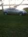 2007 Infiniti G35 - This silver 2007 Infiniti G35 coupe is seen parked on a grassy area next to a body of water.