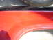 1992 Ford Ranger - A scratch is visible on the red fender of this vehicle part.