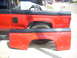 1992 Ford Ranger - Two red truck bed panels are shown, one attached to a vehicle and the other detached.