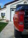 1992 Ford Ranger - A red pickup truck is parked in front of a garage with a license plate that reads 9081.
