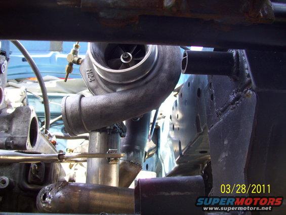 close-up of turbocharger and exhaust piping in engine bay