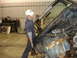 1993 Ford F-150 - A man works on the engine of a disassembled truck, revealing its internal components and wiring.