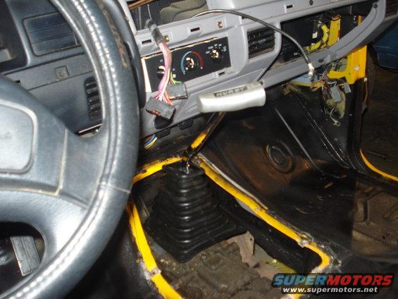 1993 Ford F-150 interior, dashboard removed, yellow trim visible, Hurst shifter, black floor matting