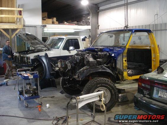 1993 Ford F-150 cab and chassis in blue and yellow, undergoing restoration