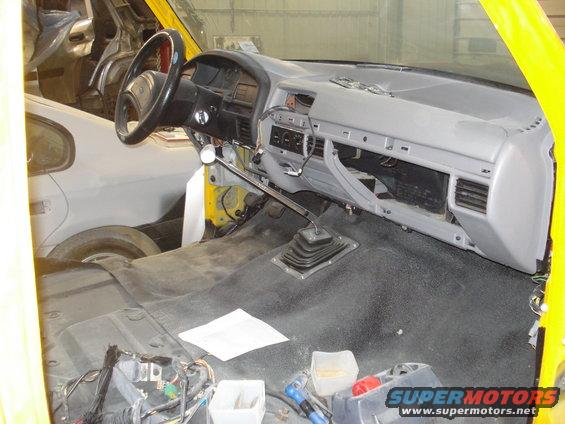 1993 Ford F-150 interior during restoration, showing dashboard, steering wheel, and floor shifter