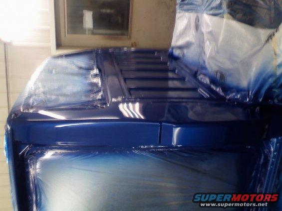 Blue 1993 Ford F-150 cab with plastic sheeting, viewed from the front