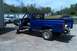 1993 Ford F-150 - A blue 1993 Ford F-150 pickup truck is shown from the front-three-quarter view, with its front end disassembled.