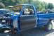 1993 Ford F-150 - A blue pickup truck is undergoing repairs with its front end disassembled and engine exposed.