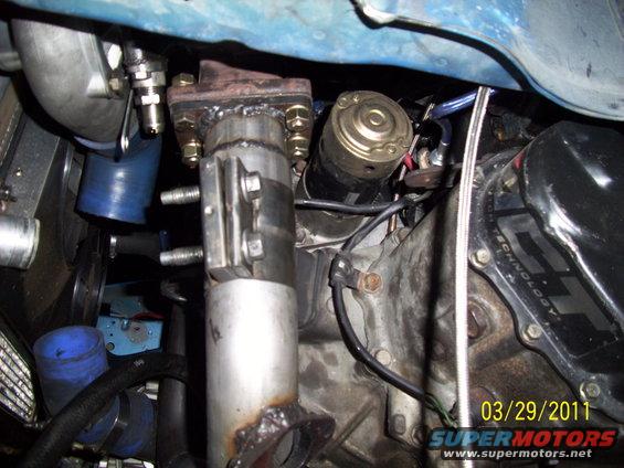 Engine bay with turbocharger, exhaust manifold, and starter motor