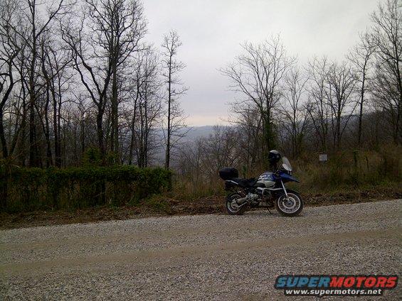 2001 BMW R1150GS ABS motorcycle parked on gravel road with trees and hills in background