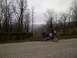 2001 BMW R1150GS ABS - Motorcycle parked on a gravel road with a wooded hillside behind it.